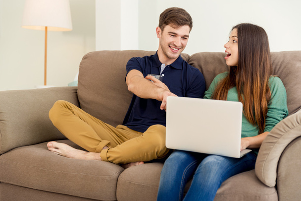 Young couple watching something on laptop - Photo, Image