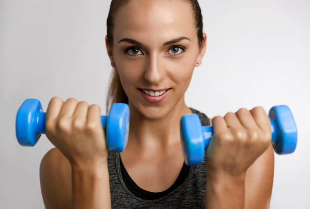 fitness woman with two dumbbells in hands - Foto, imagen