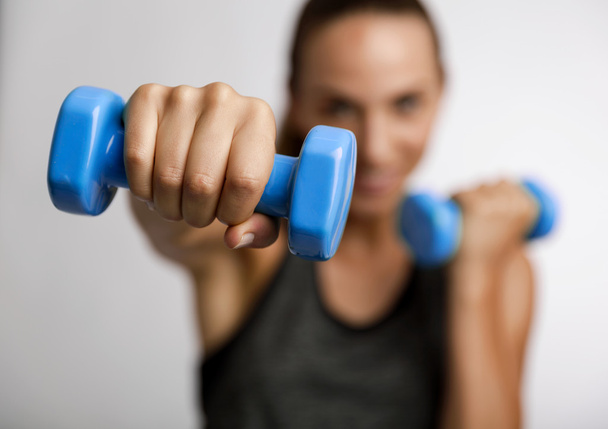 fitness woman with two dumbbells in hands - Fotó, kép