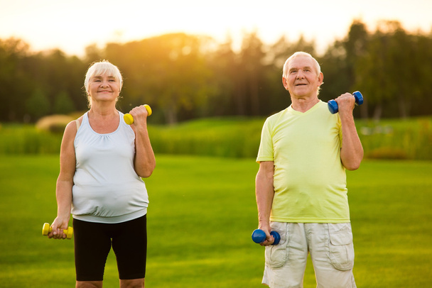 Old couple with dumbbells. - Photo, Image