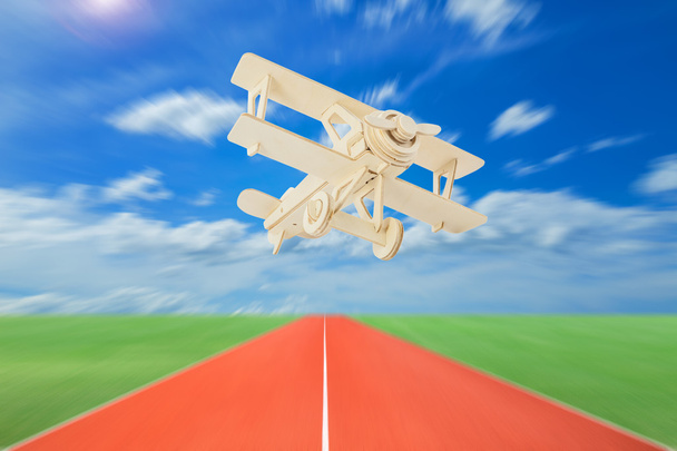 Wood airplane with runways against beautiful sky background. - Photo, Image