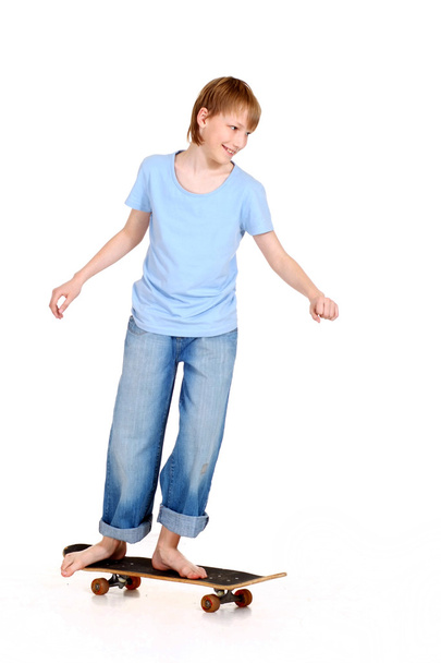 Boy standing on skateboard - Valokuva, kuva