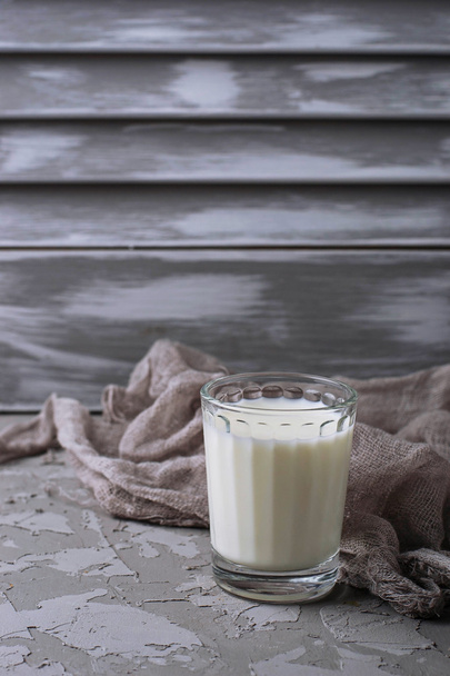 Glass of milk on gray concrete background - Φωτογραφία, εικόνα