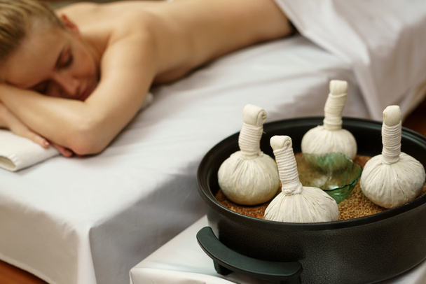 In spa. Traditional thai massage with salt bags - Фото, изображение