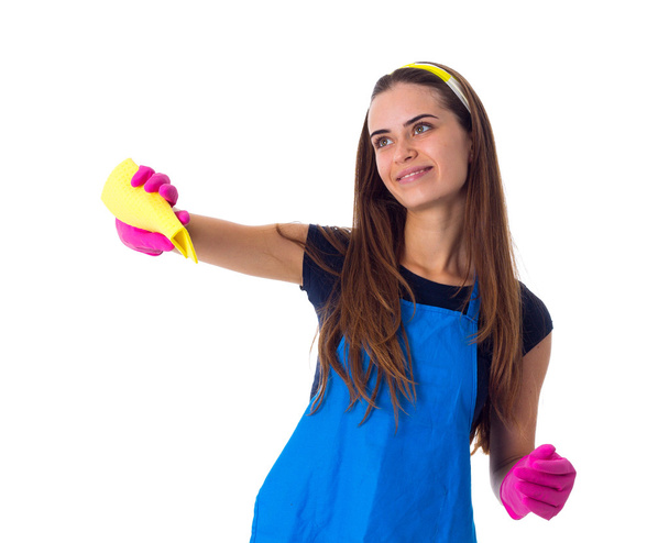 Woman in apron using a duster - Photo, Image