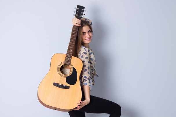 若い女性はギターを抱えて - 写真・画像