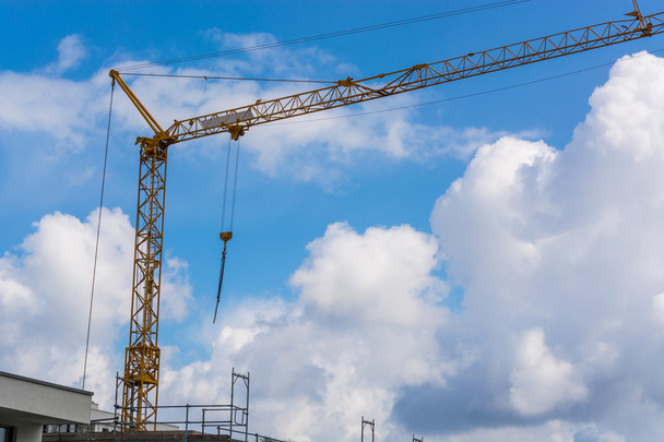 Construction crane against blue sky photographed - Fotografie, Obrázek