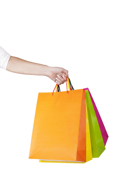 Female hand holding colorful shopping bags - Valokuva, kuva