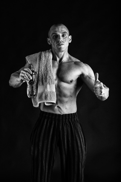 Male showing muscles in a black-and-white photos. - Zdjęcie, obraz