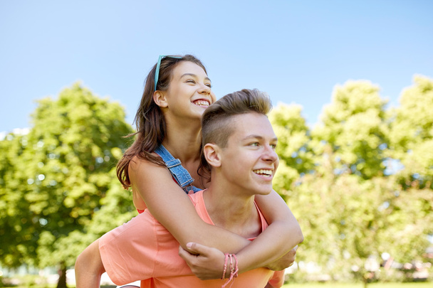 happy teenage couple having fun at summer park - Foto, Imagem