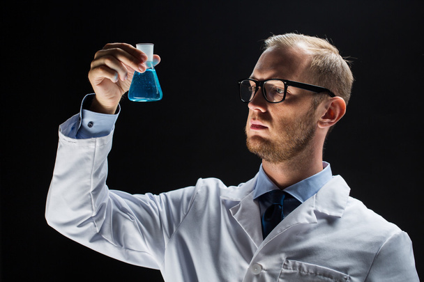 young scientist holding test flask with chemical - Foto, immagini