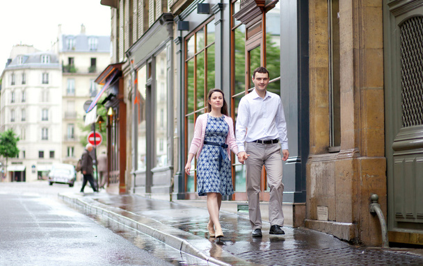 Dating couple walking in Paris after the rain - Photo, Image