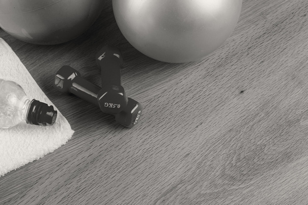 Fitness equipment on a table on a black and white photo. - Photo, Image