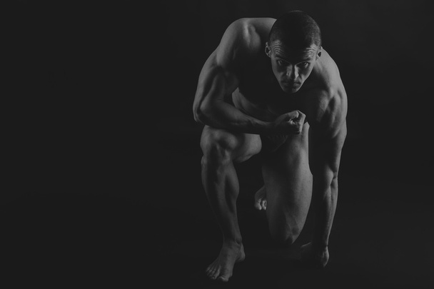 Big bodybuilder on a dark background - Photo, image