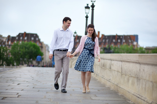Dating couple in Paris walking hand in hand - 写真・画像