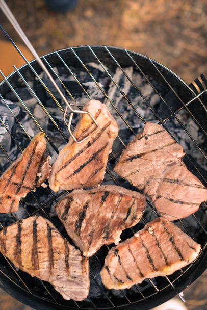 Grilling meat on charcoal grill - Photo, Image
