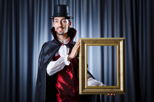 Magician with photoframe in studio - Photo, Image