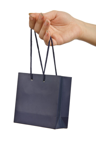 χέρι και δώρο τσάντα σε λευκό - Φωτογραφία, εικόνα