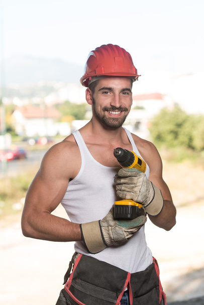 Retrato de um trabalhador com broca
 - Foto, Imagem