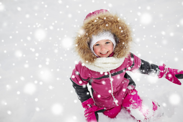 f happy little child or girl with snow in winter - 写真・画像