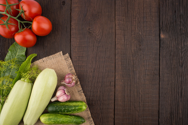 Tomatoes, garlic, cucumbers, zucchini, dill and horseradish leav - Фото, изображение