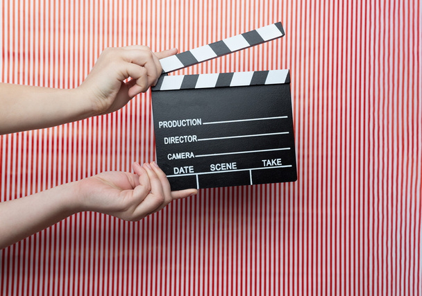 Woman holding movie clapper - Photo, Image