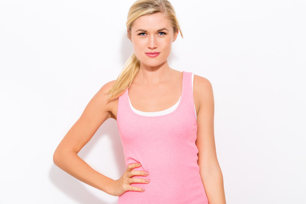fit woman standing in pink tank-top - Zdjęcie, obraz