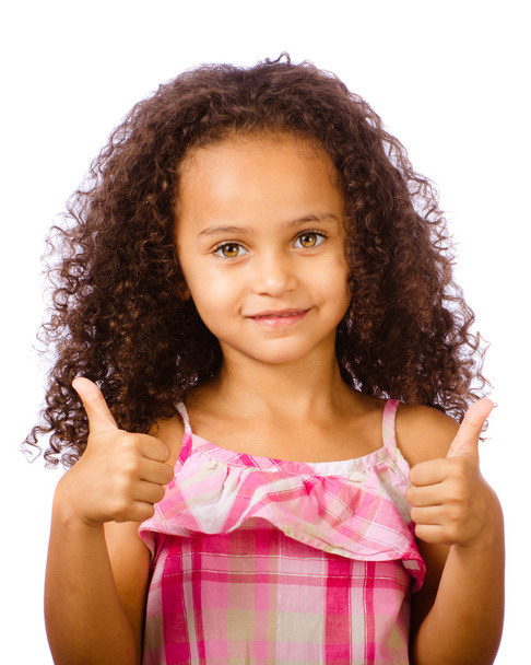 Portrait of pretty African-American mixed race child giving thumbs up against white background - Zdjęcie, obraz
