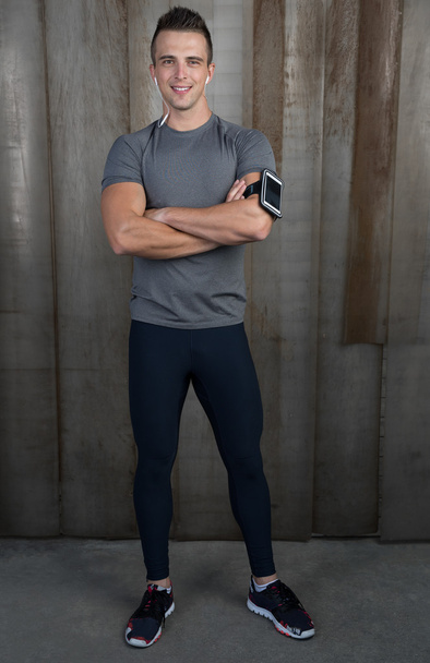 Athletic man with earbuds - Photo, image
