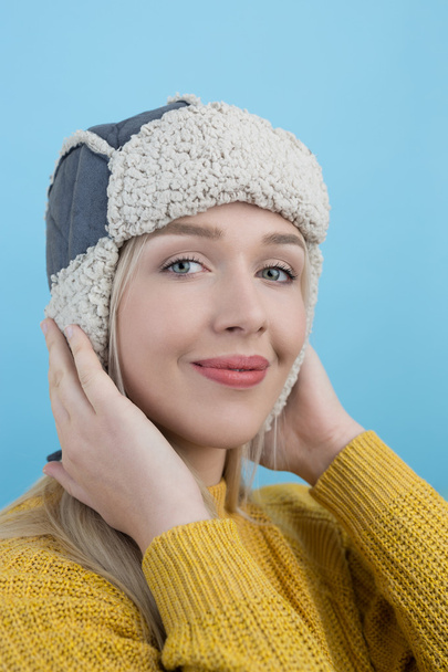 woman in a woolly winter hat with earflaps - Φωτογραφία, εικόνα