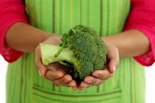 Closeup of female chef holding broccoli - Foto, imagen
