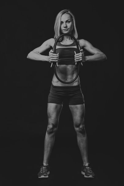 Professional fitness athlete on a dark background. - Photo, Image