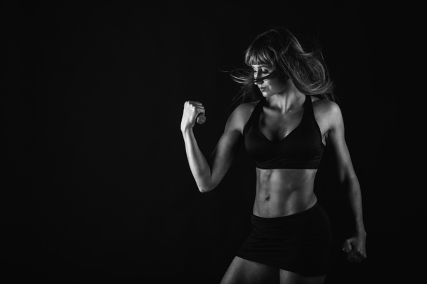 Fitness girl posing on black - Photo, Image