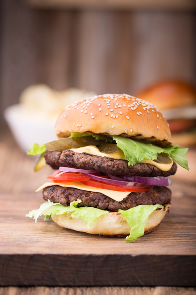 Double burger on wooden board. Close up - Foto, Imagen