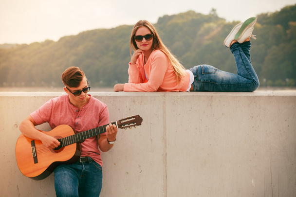 Happy couple with guitar outdoor - Valokuva, kuva