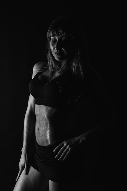 Fitness girl posing on black - Photo, Image