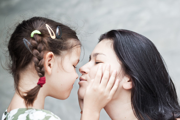 Daughter kissing mother - Фото, изображение