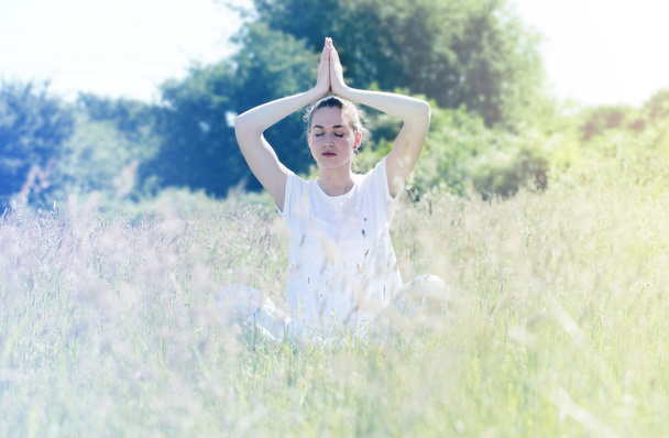 zen beautiful yoga girl on grass, sunny retro toned effects - Photo, Image