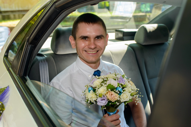 Young bridegroom arriving in a car - Photo, Image