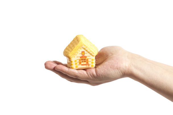 Man hand and toy house; real estate presentation - Photo, Image