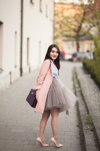 Young Asians girl with modern dress posing in an old Krakow - Фото, зображення