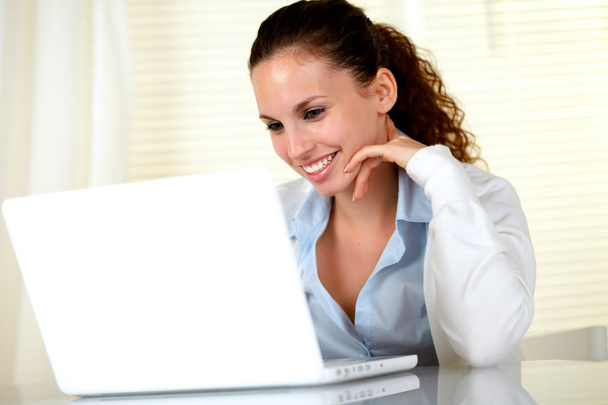 Smiling caucasian female working on laptop - Φωτογραφία, εικόνα