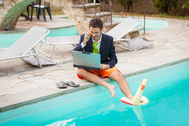 Funny Young Businessman with SwimmingTrunks next to the Pool - Fotoğraf, Görsel