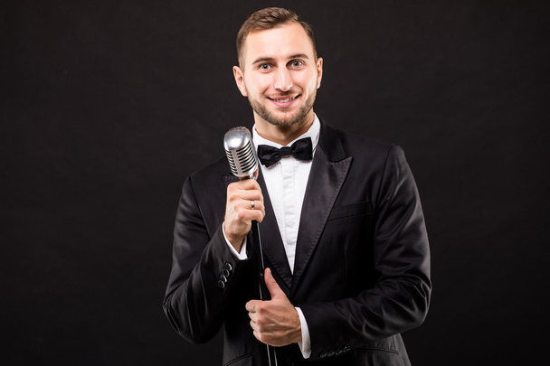 Portrait young showman in suit singing - Photo, Image