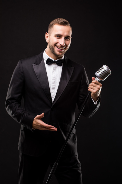 Handsome Man in suit singing with the microphone  - Zdjęcie, obraz