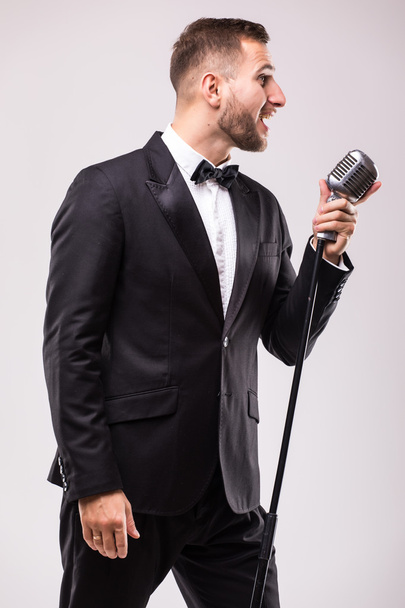 Takım elbise şarkı mikrofon üzerinde genç adam - Fotoğraf, Görsel