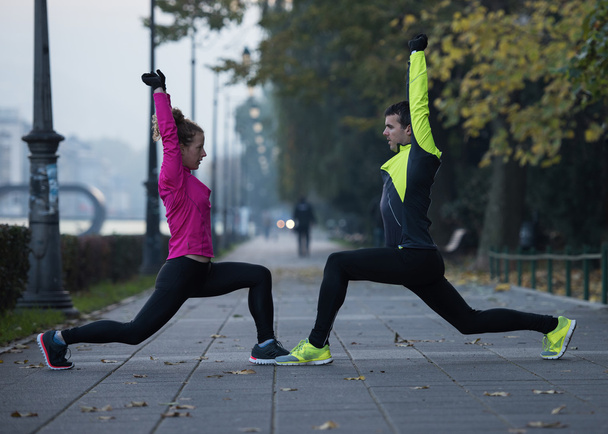 a young couple warming up before jogging - Foto, immagini