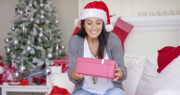Excited young woman opening a Christmas gift - Footage, Video