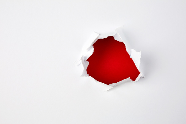 red hole in the paper.  - Фото, изображение