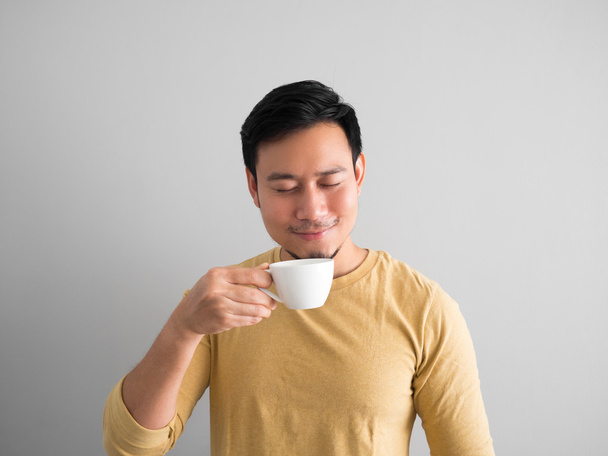 Asian man drinks coffee. - Fotoğraf, Görsel